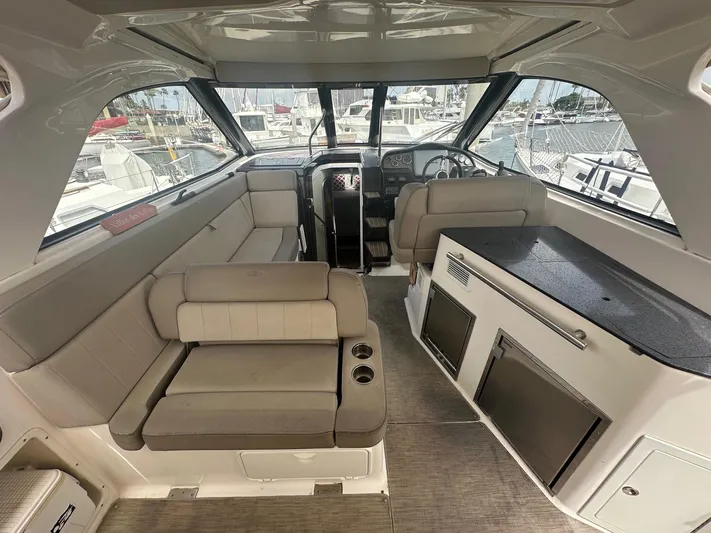 Panacea Yacht Photos Pics Interior of 2015 Regal 35 Sport Coupe boat with seating and helm.
