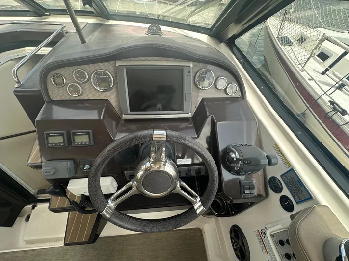 Panacea Yacht Photos Pics 2015 Regal 35 Sport Coupe dashboard with steering wheel and control panel.