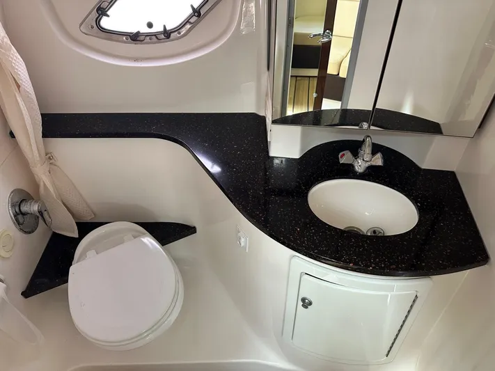 Panacea Yacht Photos Pics 2015 Regal 35 Sport Coupe bathroom with sleek black countertop and modern fixtures.
