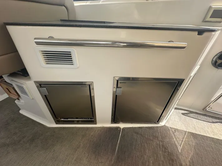 Panacea Yacht Photos Pics 2015 Regal 35 Sport Coupe interior with dual stainless steel cabinets.