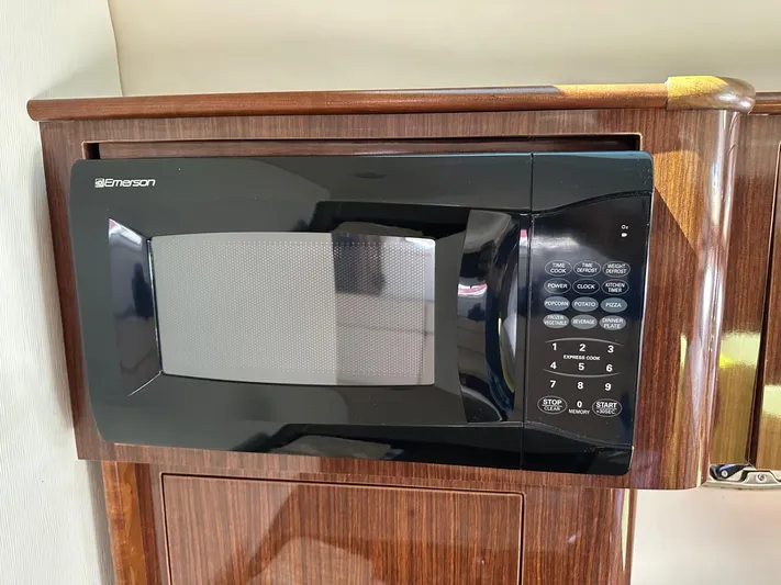 Panacea Yacht Photos Pics Built-in black microwave in 2015 Regal 35 Sport Coupe yacht kitchen.