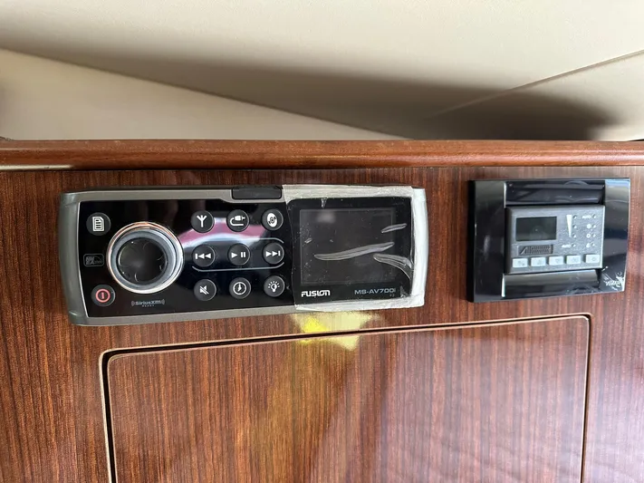 Panacea Yacht Photos Pics Control panel on 2015 Regal 35 Sport Coupe with wood finish and audio system.
