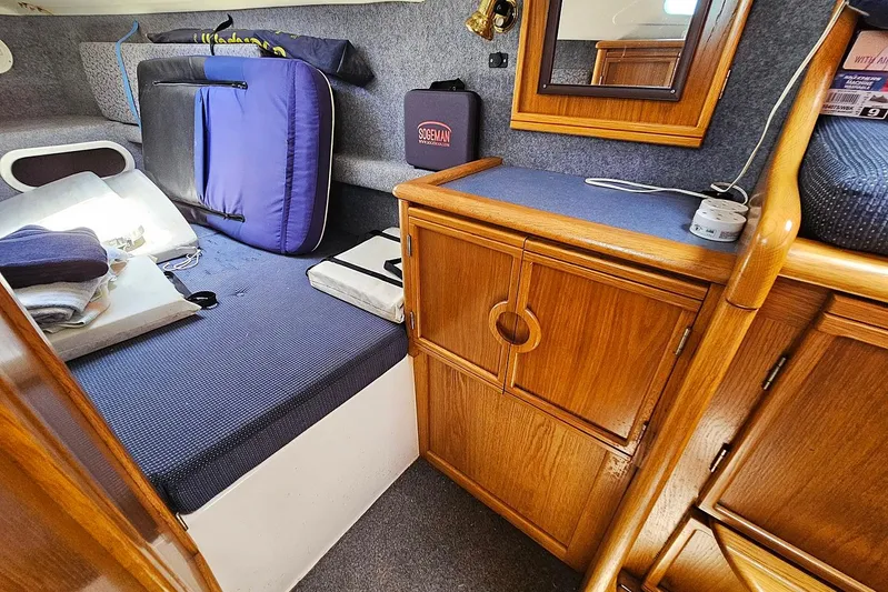 Zephyros Yacht Photos Pics Cozy cabin interior of 2009 Seawind 36XL with wooden cabinetry and seating area.