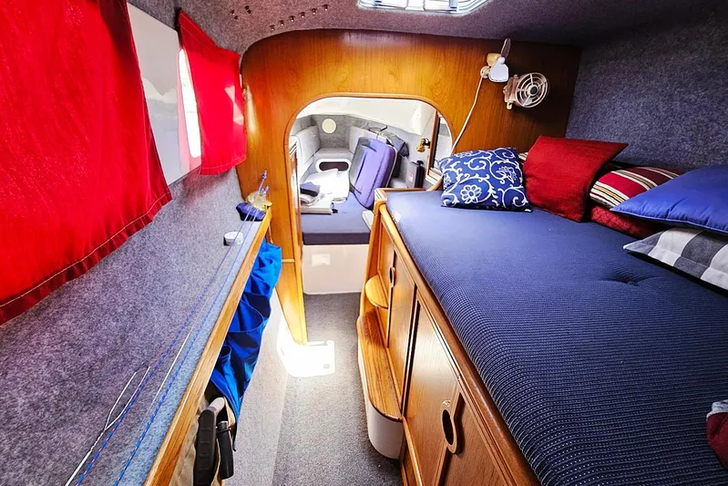 Zephyros Yacht Photos Pics Cozy interior cabin of 2009 Seawind 36XL catamaran with colorful cushions and wooden accents.