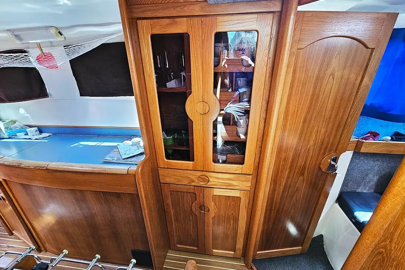 Zephyros Yacht Photos Pics Interior of 2009 Seawind 36XL yacht with wooden cabinetry and blue countertop.