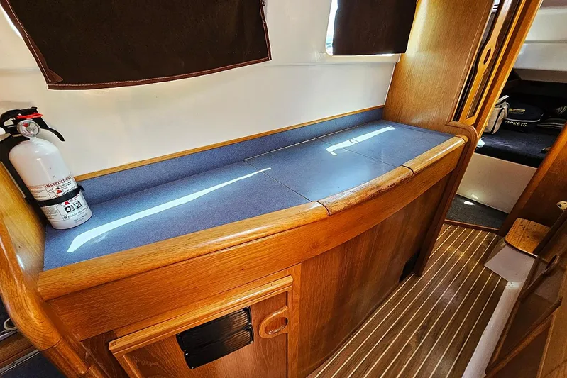 Zephyros Yacht Photos Pics Interior of 2009 Seawind 36XL yacht with wooden cabinetry and fire extinguisher.