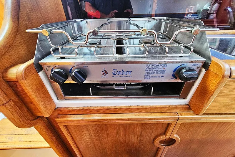 Zephyros Yacht Photos Pics Stove in 2009 Seawind 36XL yacht kitchen, featuring wooden cabinetry and Tudor brand.