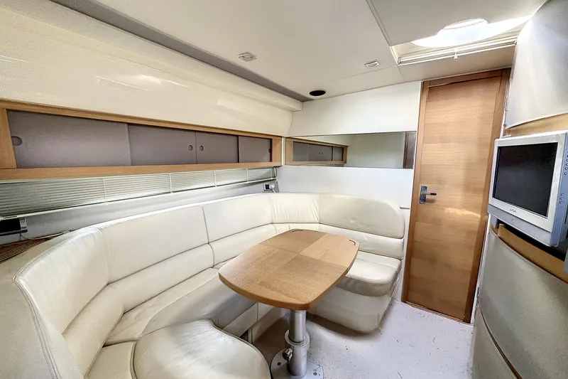  Yacht Photos Pics Interior of 2010 Fairline Targa 38 yacht with cream seating and wooden table.