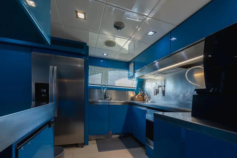  Yacht Photos Pics Modern kitchen interior on 2012 Ferretti Yachts Custom Line 100, featuring sleek blue cabinetry.