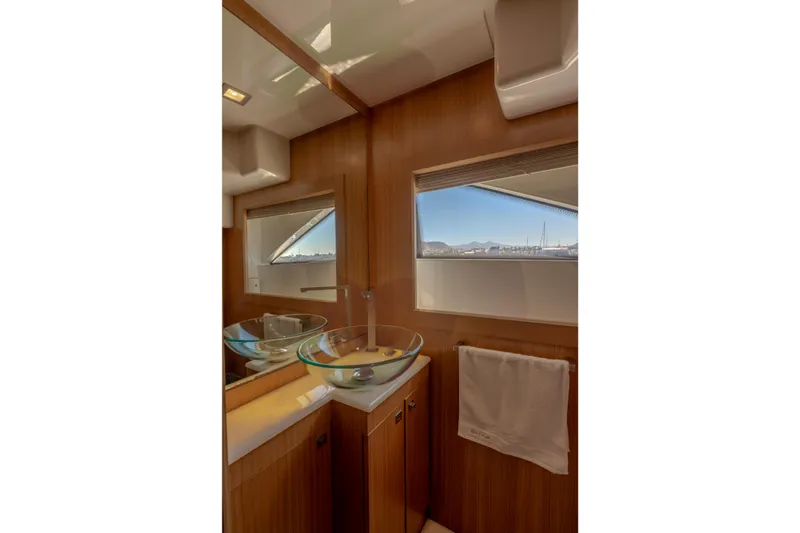 Yacht Photos Pics Luxurious bathroom interior of 2012 Ferretti Yachts Custom Line 100 with glass sink and window view.