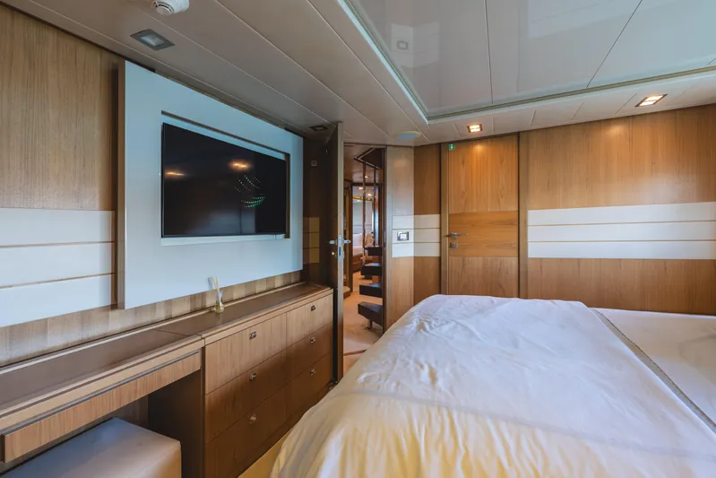  Yacht Photos Pics Luxurious bedroom interior of 2012 Ferretti Yachts Custom Line 100 with modern wood paneling.