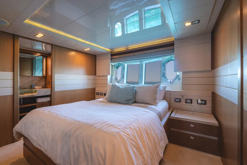  Yacht Photos Pics Luxurious bedroom interior on 2012 Ferretti Yachts Custom Line 100, featuring elegant wood finishes.