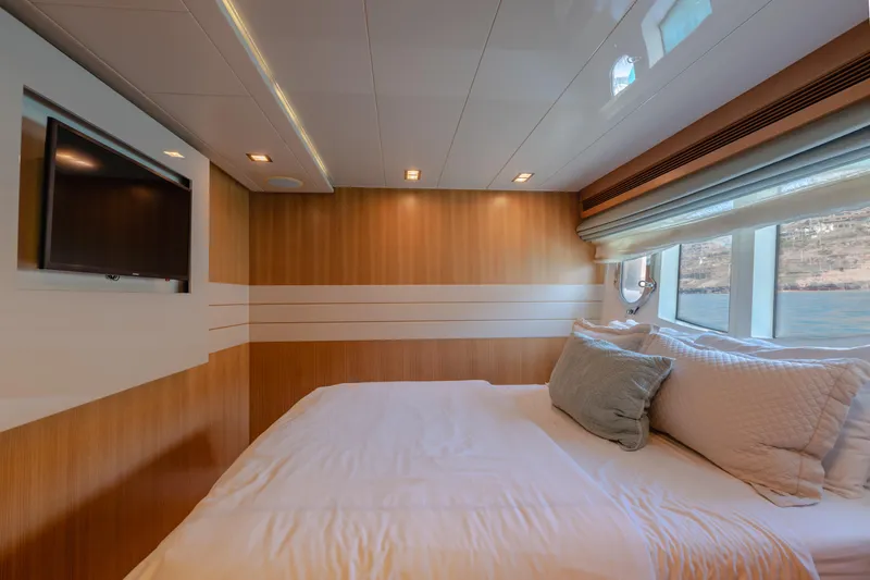  Yacht Photos Pics Luxurious bedroom interior on 2012 Ferretti Yachts Custom Line 100, featuring elegant wood paneling.