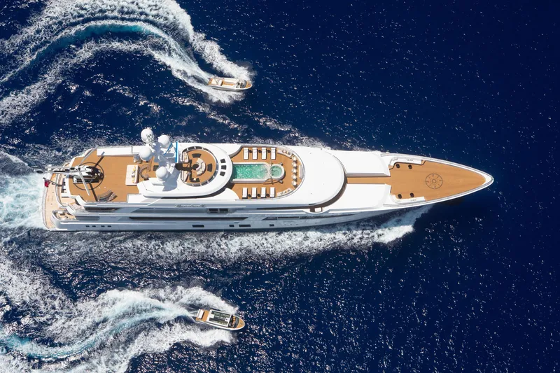 Boardwalk Yacht Photos Pics Luxurious 2021 Feadship Custom yacht cruising with tenders in deep blue ocean.