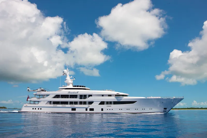 Boardwalk Yacht Photos Pics Luxurious 2021 Feadship Custom yacht cruising under a clear blue sky.