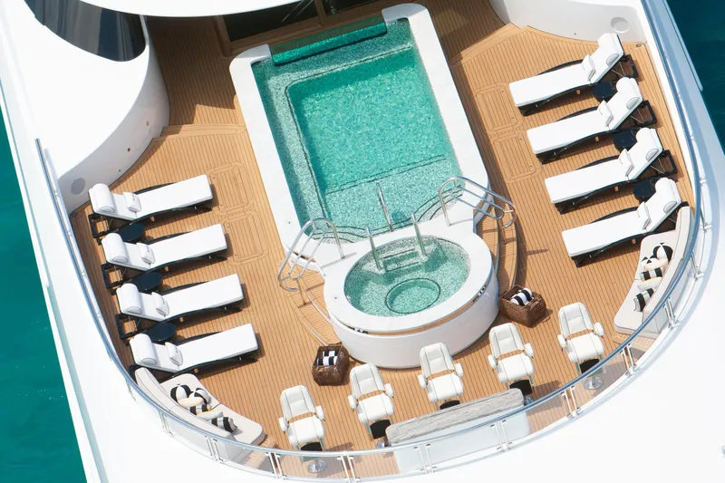 Boardwalk Yacht Photos Pics Luxurious Feadship yacht deck with pool, sun loungers, and elegant seating, 2021 model.