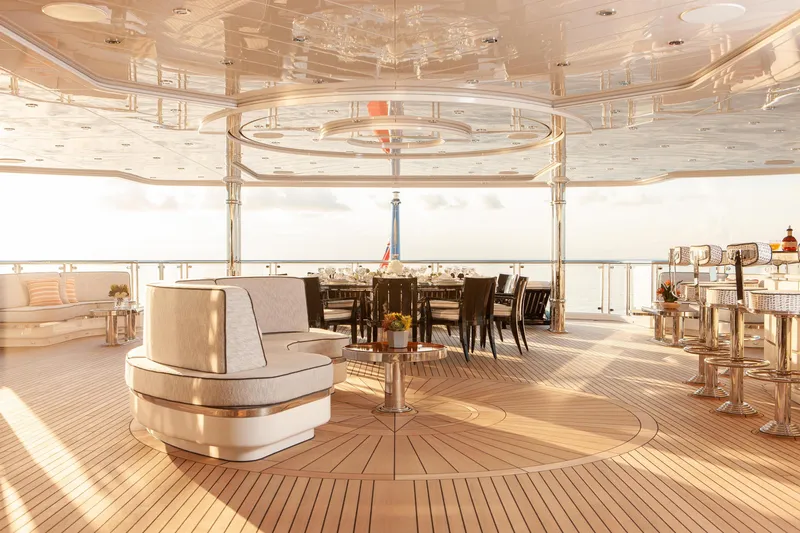 Boardwalk Yacht Photos Pics Luxurious 2021 Feadship Custom yacht deck with elegant seating and dining area at sunset.