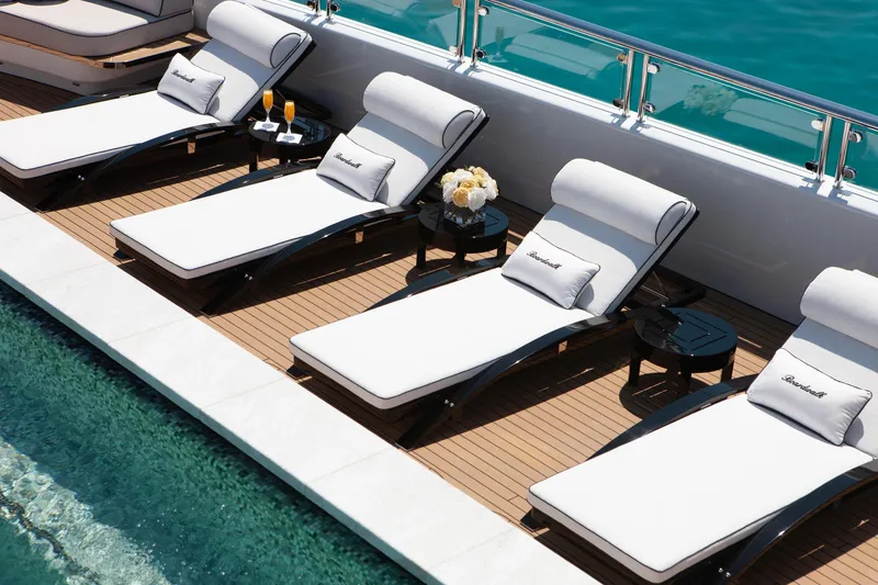 Boardwalk Yacht Photos Pics Luxurious Feadship Custom 2021 yacht deck with sun loungers and poolside view.