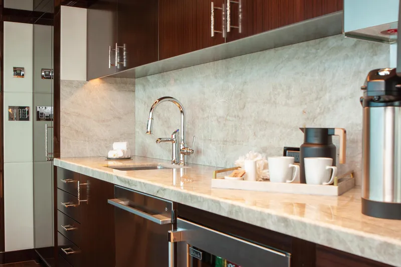 Boardwalk Yacht Photos Pics Luxurious yacht kitchen with marble countertop, modern faucet, and coffee set. Feadship Custom 2021.