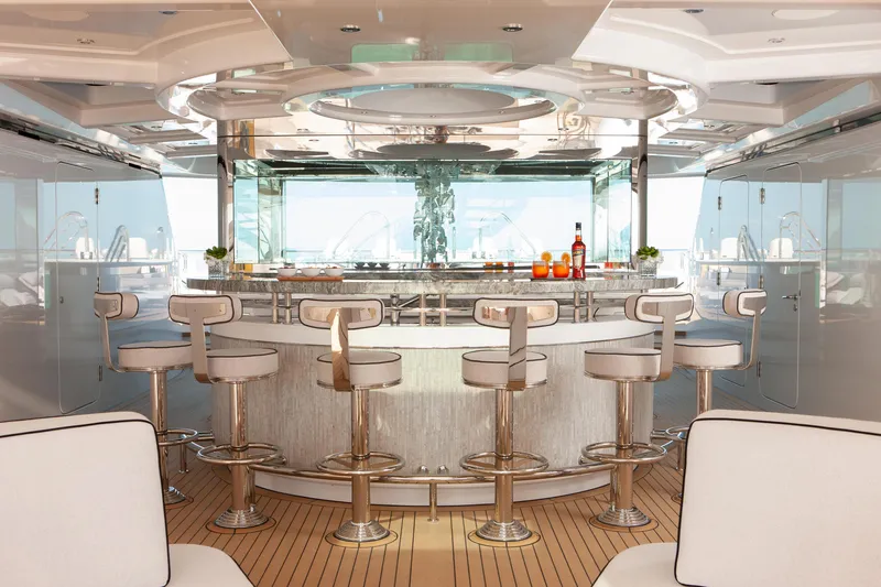 Boardwalk Yacht Photos Pics Luxurious yacht bar interior on 2021 Feadship Custom, featuring sleek stools and modern design.