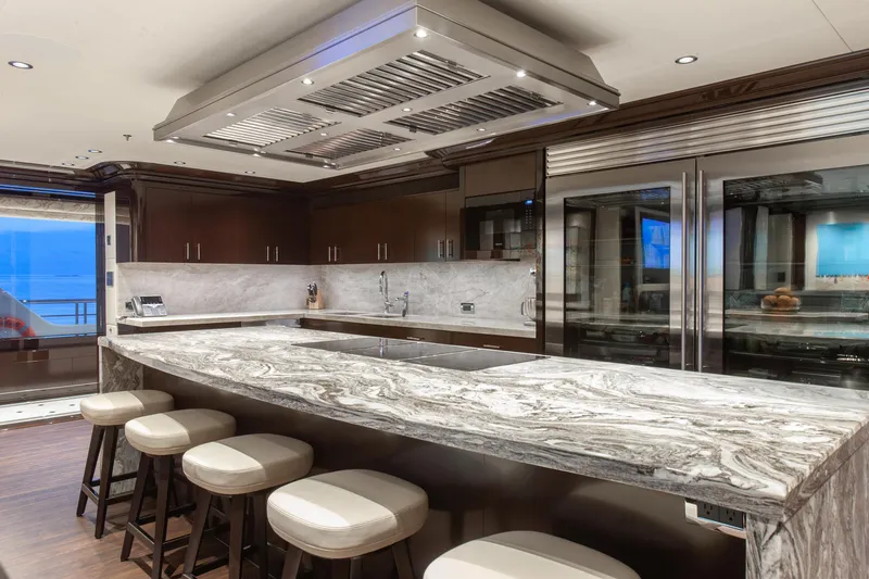 Boardwalk Yacht Photos Pics Luxurious yacht kitchen with marble countertops, modern appliances, and elegant seating. Feadship Custom 2021.