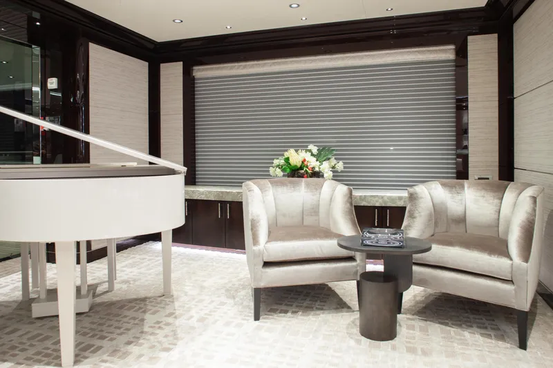 Boardwalk Yacht Photos Pics Luxurious Feadship 2021 yacht interior with grand piano, elegant seating, and floral arrangement.