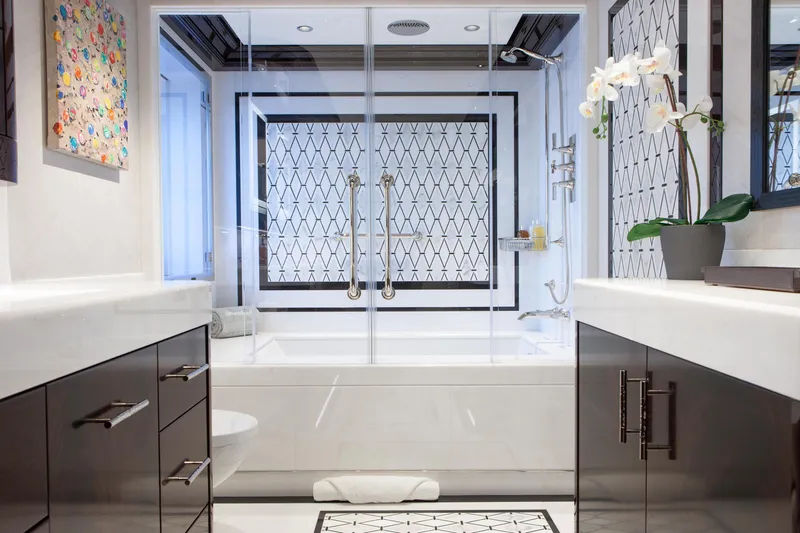 Boardwalk Yacht Photos Pics Luxurious yacht bathroom with modern design, featuring elegant fixtures and geometric tile patterns.