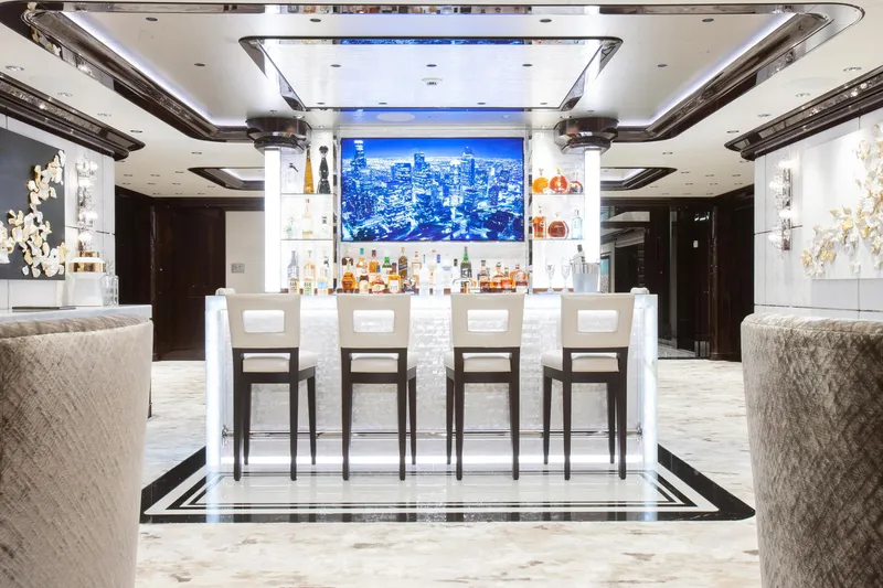 Boardwalk Yacht Photos Pics Luxurious yacht interior bar with modern design, featuring plush seating and illuminated shelves.
