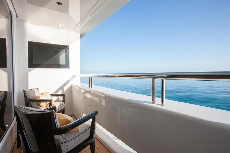 Boardwalk Yacht Photos Pics Private yacht balcony with ocean view, featuring comfortable seating on a 2021 Feadship Custom.