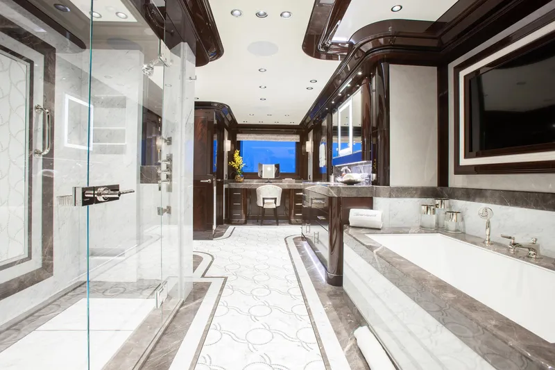 Boardwalk Yacht Photos Pics Luxurious yacht bathroom interior with marble accents, featuring a spacious shower and bathtub, Feadship 2021.