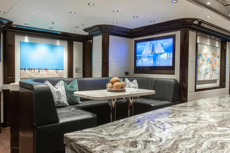 Boardwalk Yacht Photos Pics Luxurious Feadship yacht interior with elegant seating, modern art, and marble table, 2021 model.