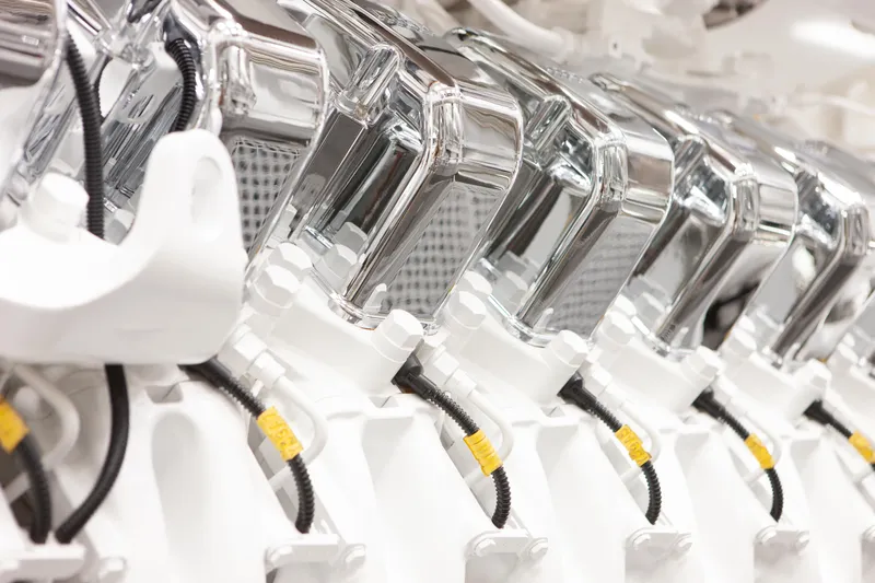 Boardwalk Yacht Photos Pics Close-up of a 2021 Feadship Custom yacht engine, showcasing chrome and white components.