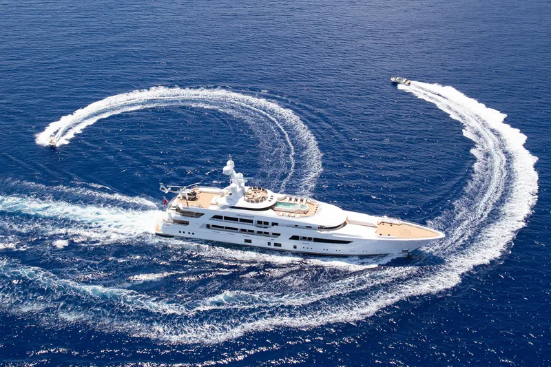 Boardwalk Yacht Photos Pics Luxurious 2021 Feadship Custom yacht cruising with speedboats in open blue sea.