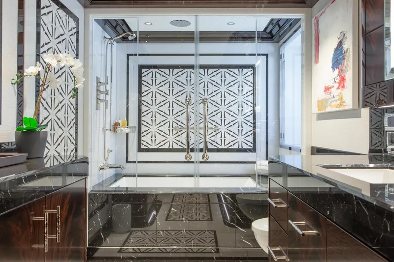 Boardwalk Yacht Photos Pics Luxurious Feadship 2021 yacht bathroom with elegant black marble and geometric shower design.