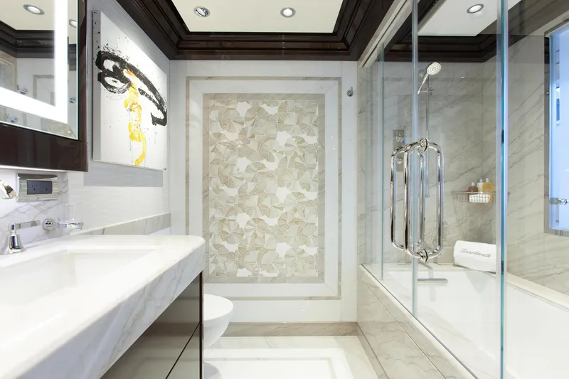 Boardwalk Yacht Photos Pics Luxurious Feadship 2021 yacht bathroom with elegant marble and modern art decor.