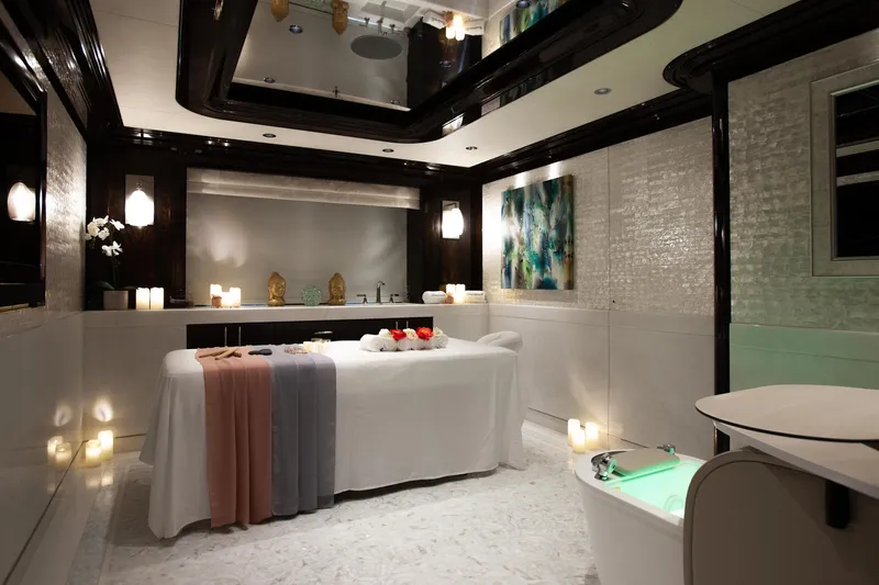 Boardwalk Yacht Photos Pics Luxurious spa room on 2021 Feadship Custom yacht, featuring massage table and ambient lighting.