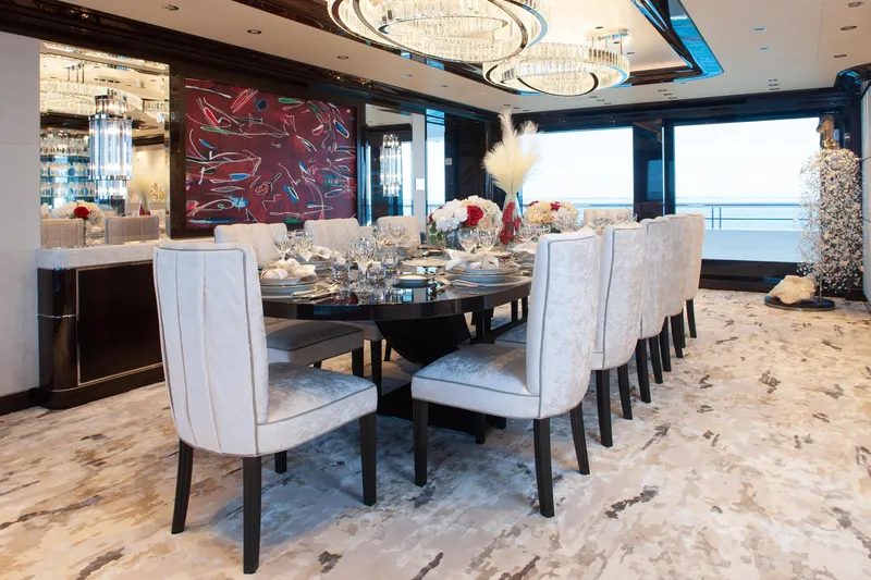 Boardwalk Yacht Photos Pics Luxurious dining area on 2021 Feadship Custom yacht, featuring elegant decor and panoramic ocean views.