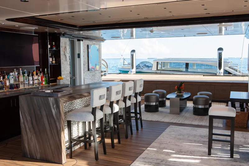 Boardwalk Yacht Photos Pics Luxurious Feadship Costum 2021 yacht interior with bar, seating, and ocean view.