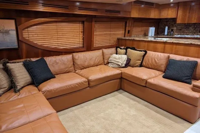  Yacht Photos Pics Luxurious interior of 2007 Hatteras 68 Convertible yacht with leather seating and wooden accents.