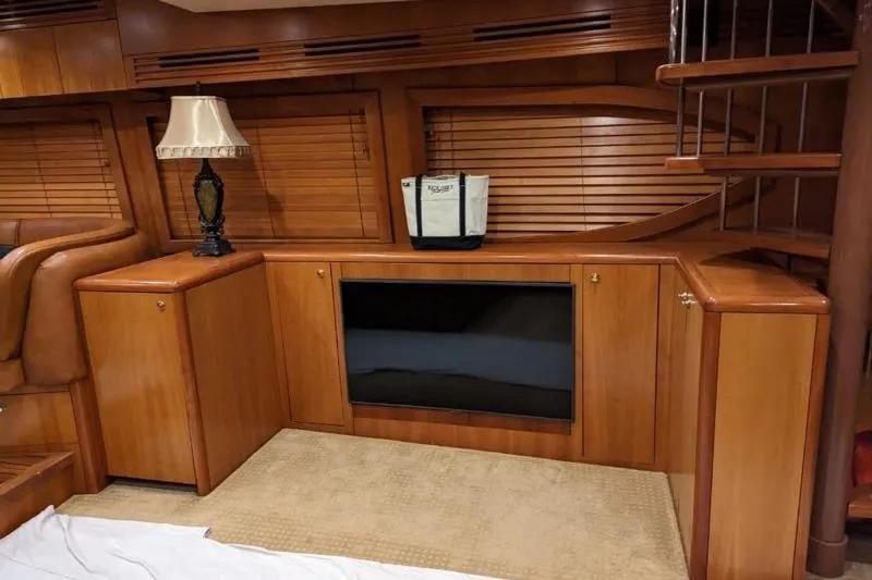  Yacht Photos Pics Luxurious wooden interior of a 2007 Hatteras 68 Convertible yacht with elegant furnishings.