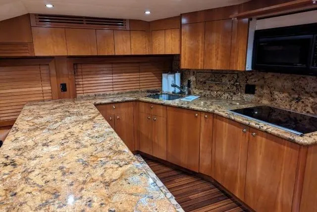  Yacht Photos Pics Luxurious kitchen interior of 2007 Hatteras 68 Convertible yacht with granite countertops.