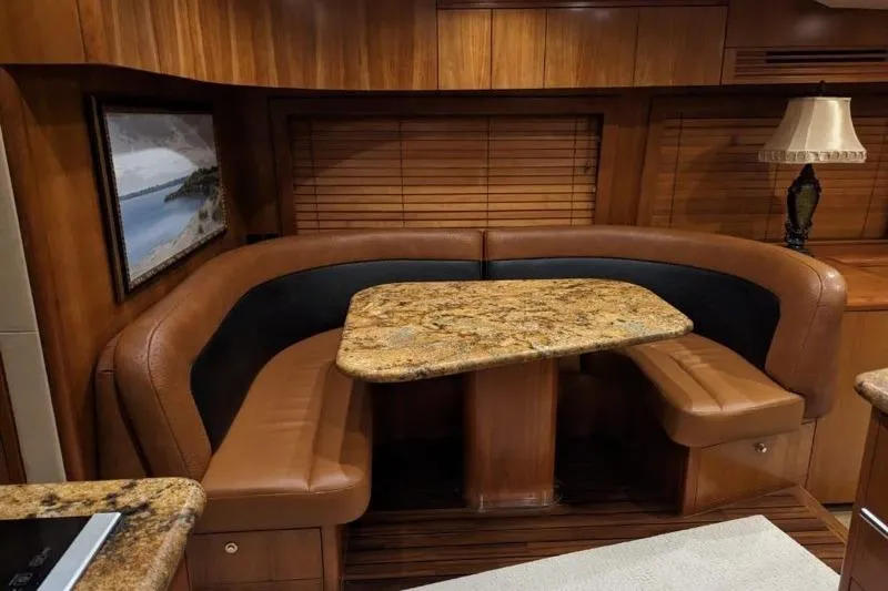  Yacht Photos Pics Luxurious interior of 2007 Hatteras 68 Convertible yacht with elegant dining area.