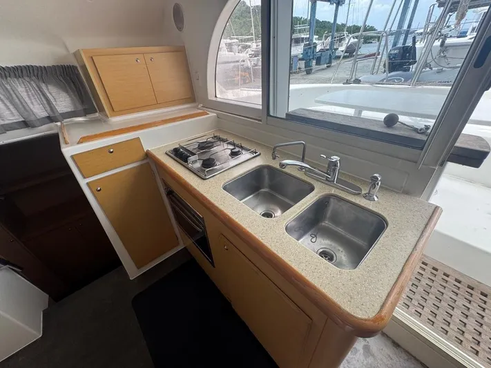 Isaphil Yacht Photos Pics 2013 Lagoon 380 S2 yacht kitchen with dual sinks and stove, dock view.