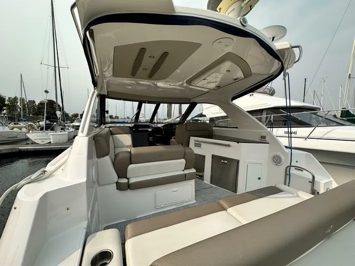  Yacht Photos Pics 2014 Regal Sport Coupe boat interior with seating and kitchenette at marina.