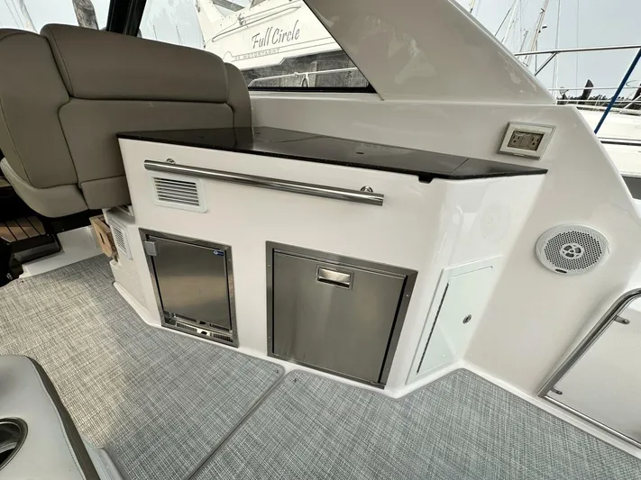  Yacht Photos Pics 2014 Regal Sport Coupe interior with kitchenette, featuring stainless steel appliances and modern design.