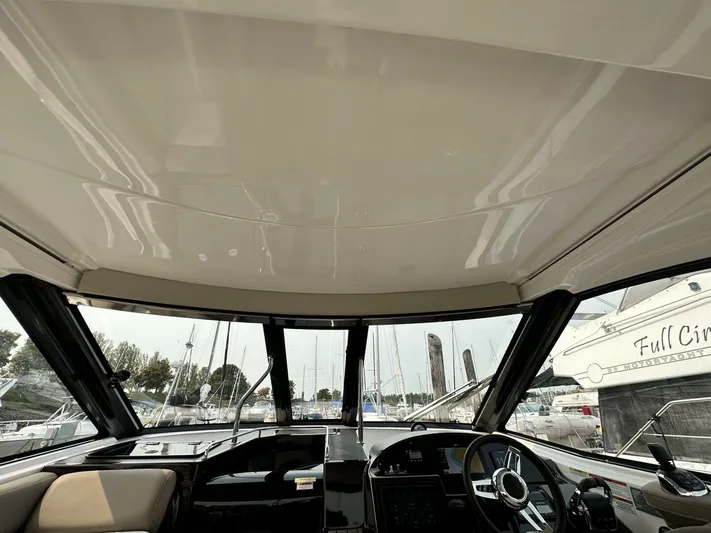  Yacht Photos Pics Interior view of 2014 Regal Sport Coupe boat cockpit with steering wheel and dashboard.