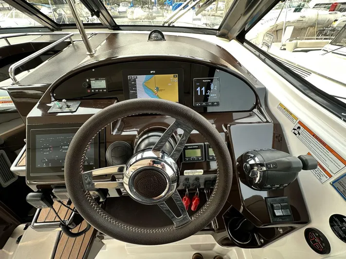  Yacht Photos Pics 2014 Regal Sport Coupe dashboard with steering wheel, navigation screens, and controls.