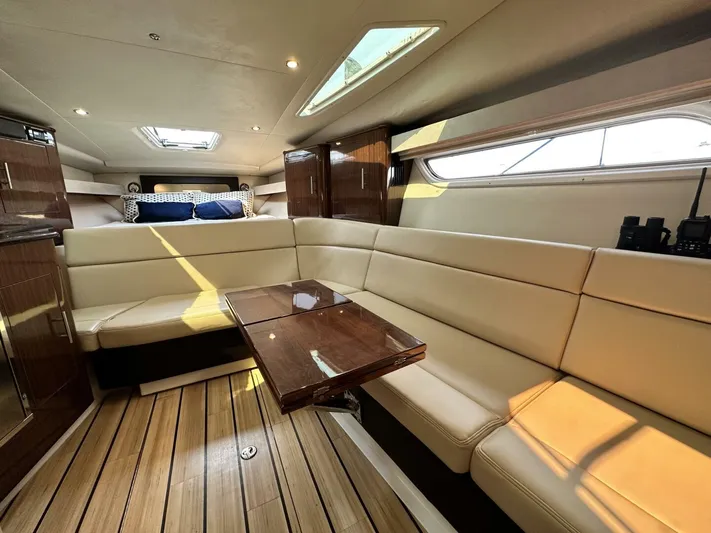  Yacht Photos Pics Luxurious interior of a 2014 Regal Sport Coupe yacht with plush seating and wooden accents.