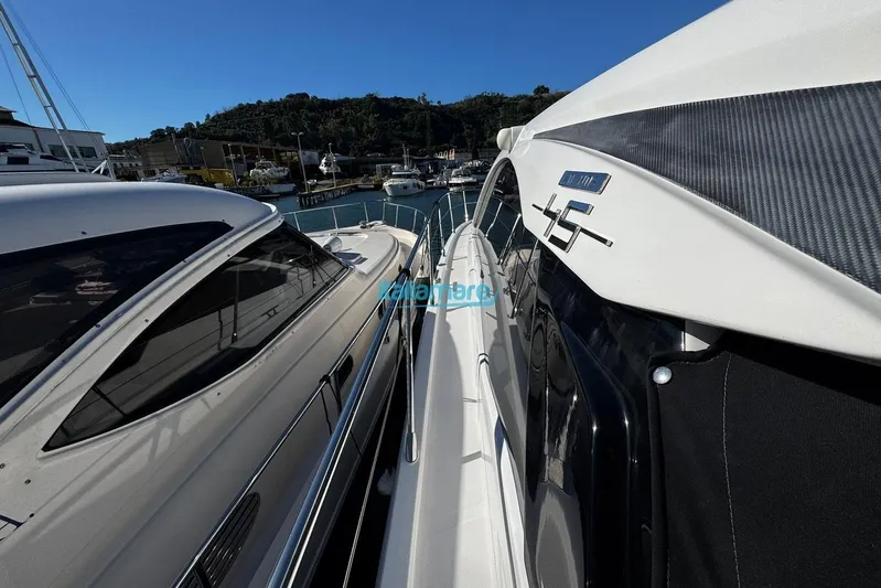  Yacht Photos Pics Azimut Atlantis 45 yacht, 2020 model, docked in a marina under clear blue skies.