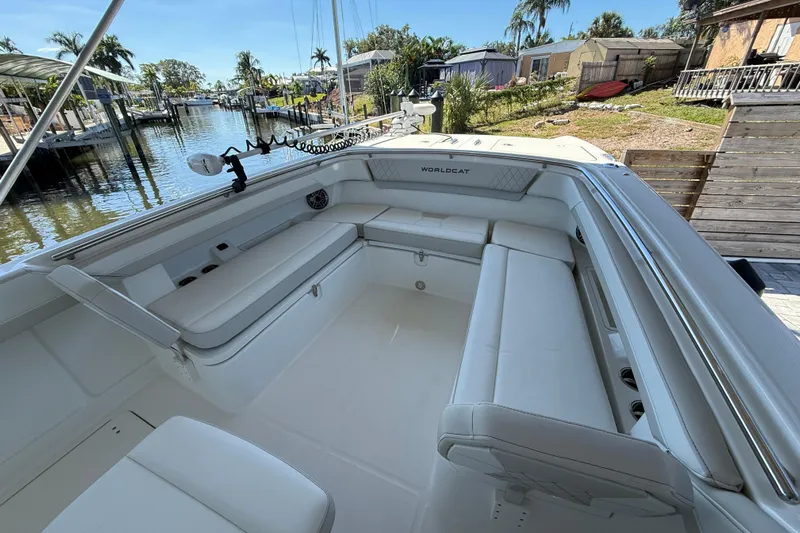  Yacht Photos Pics 2025 World Cat 280 CC-X boat interior with spacious seating, docked by a scenic waterfront.